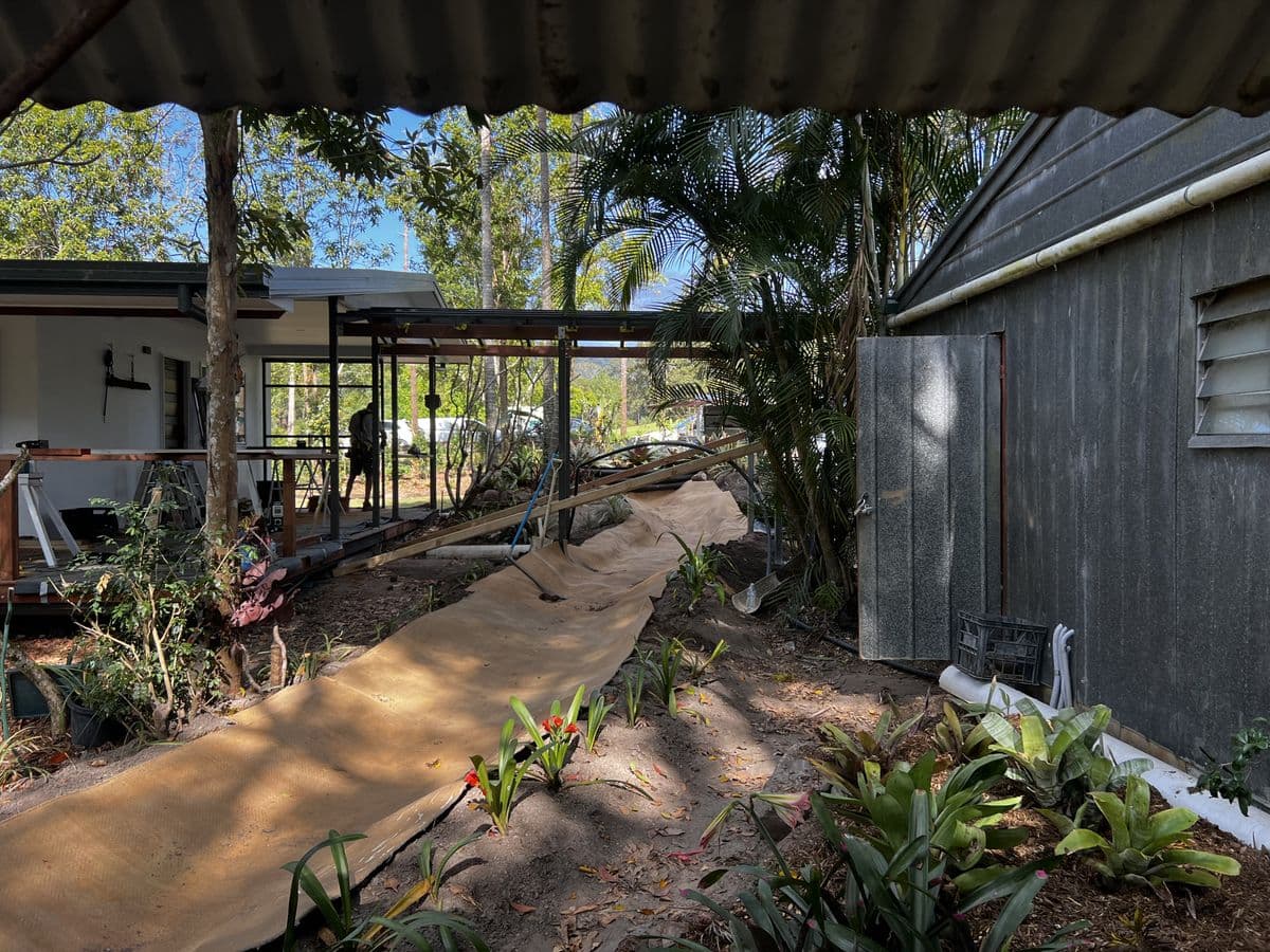 Fibreglass creek channel being laid along garden path